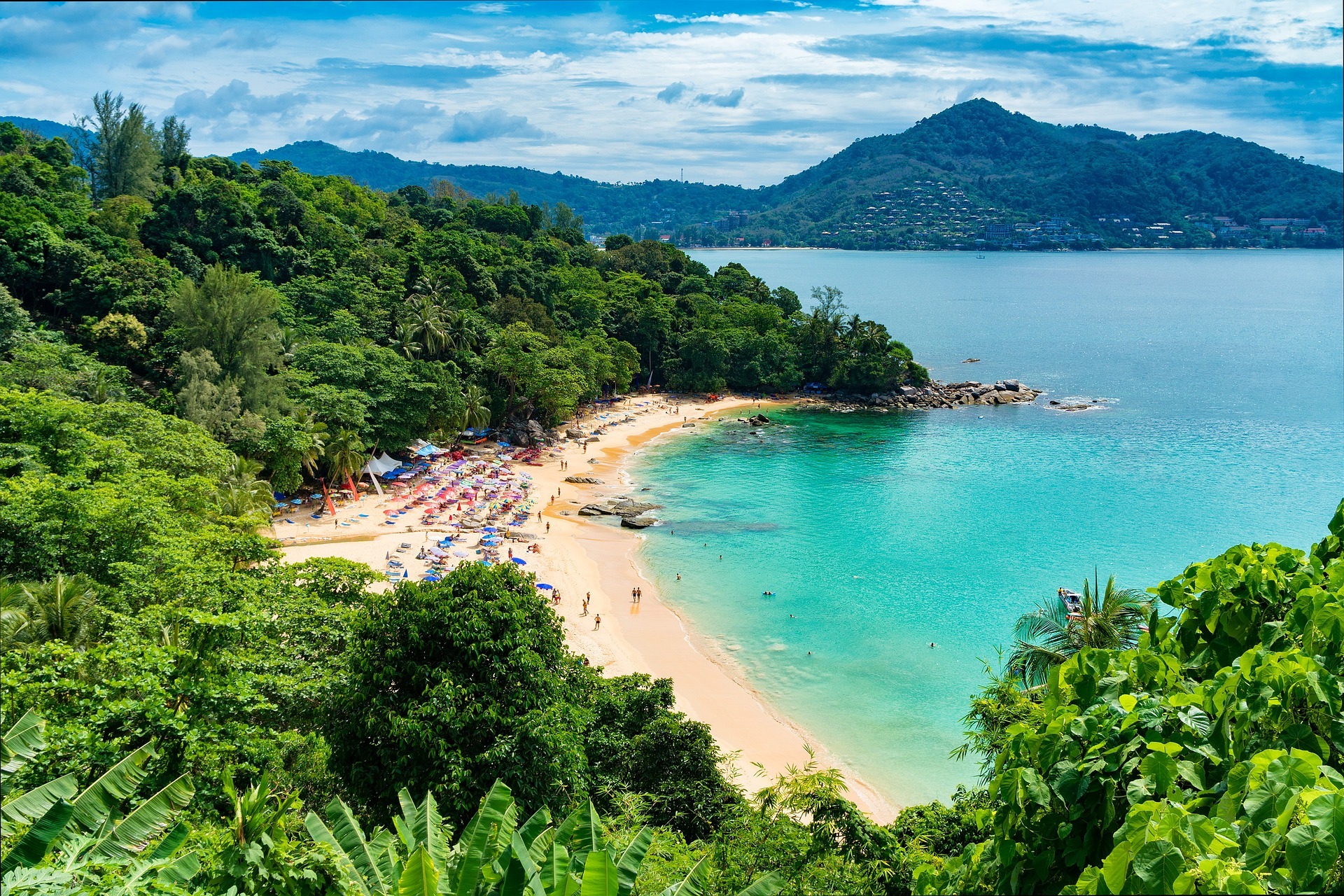 Sandy beach and wooded coastline in Phuket
