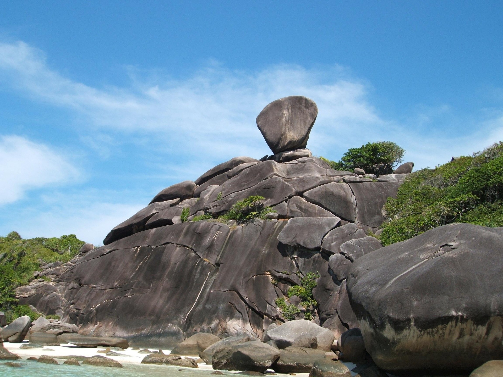 Sail Rock above the granite shoreline on Koh Similan